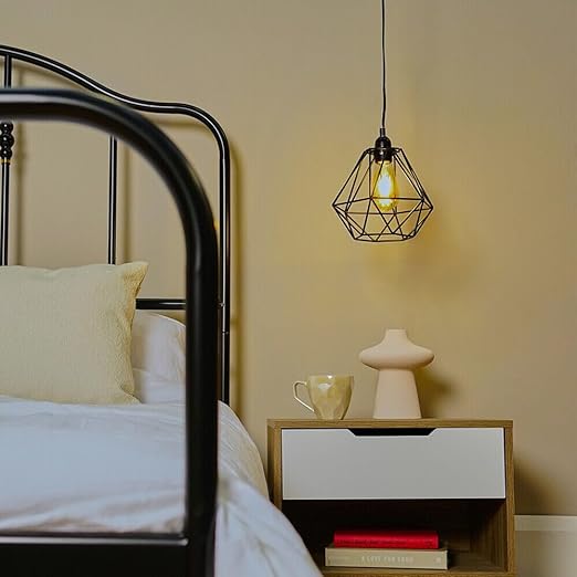 Modern geometric black pendant lamp beside bed